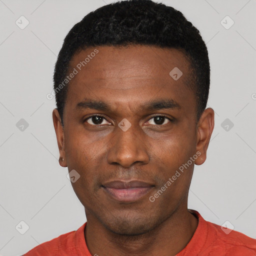 Joyful black young-adult male with short  black hair and brown eyes