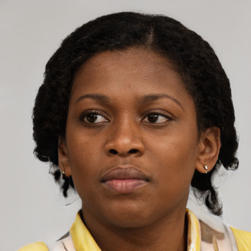 Neutral black young-adult female with medium  brown hair and brown eyes
