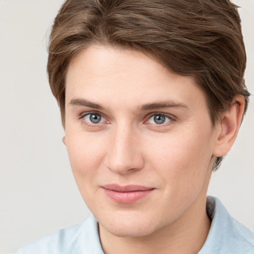 Joyful white young-adult female with short  brown hair and grey eyes