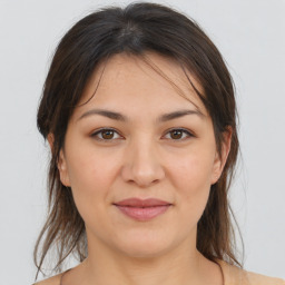 Joyful white young-adult female with medium  brown hair and brown eyes