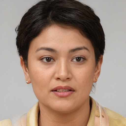 Joyful latino young-adult female with short  brown hair and brown eyes
