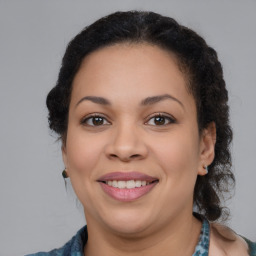 Joyful latino young-adult female with medium  brown hair and brown eyes