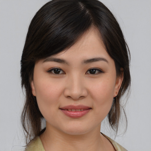 Joyful asian young-adult female with medium  brown hair and brown eyes