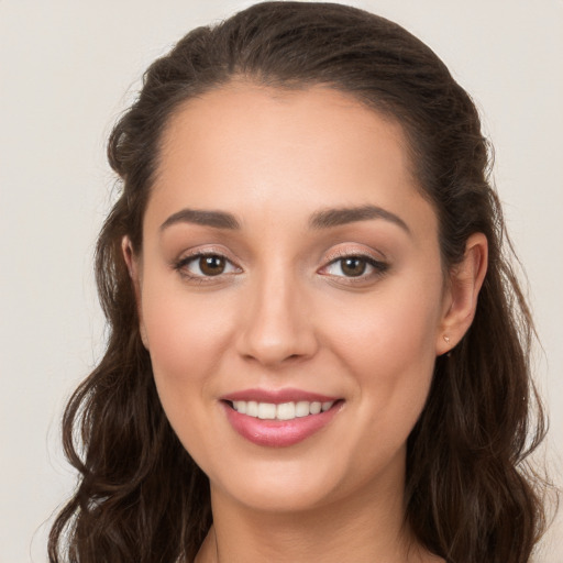 Joyful white young-adult female with long  brown hair and brown eyes