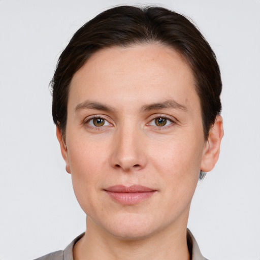 Joyful white young-adult female with short  brown hair and grey eyes