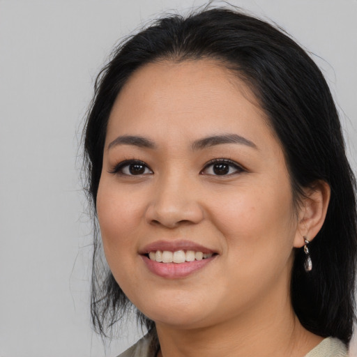 Joyful asian young-adult female with medium  black hair and brown eyes