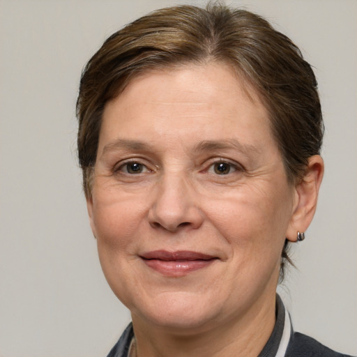 Joyful white adult female with medium  brown hair and grey eyes