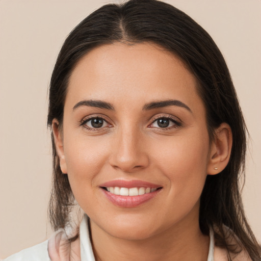 Joyful white young-adult female with long  brown hair and brown eyes