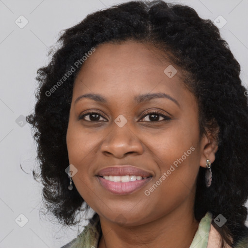 Joyful black young-adult female with long  brown hair and brown eyes