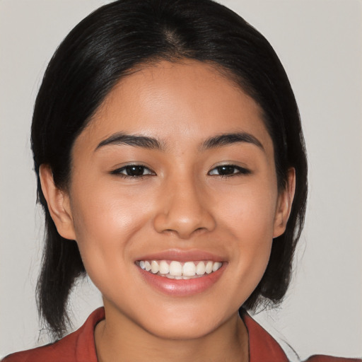 Joyful latino young-adult female with medium  black hair and brown eyes