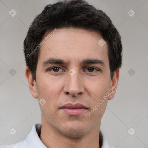 Joyful white young-adult male with short  black hair and brown eyes