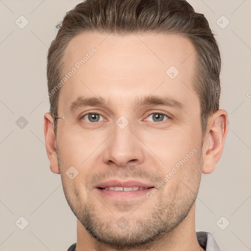 Joyful white young-adult male with short  brown hair and grey eyes