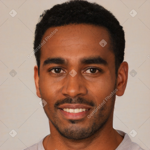 Joyful black young-adult male with short  black hair and brown eyes