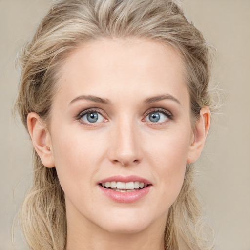 Joyful white young-adult female with long  brown hair and blue eyes