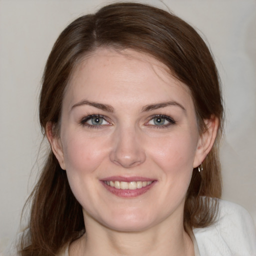 Joyful white young-adult female with medium  brown hair and blue eyes