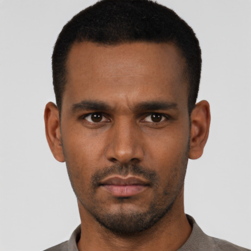 Neutral latino young-adult male with short  black hair and brown eyes