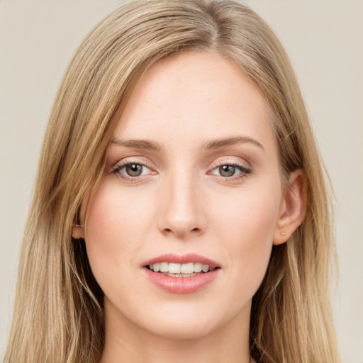 Joyful white young-adult female with long  brown hair and green eyes