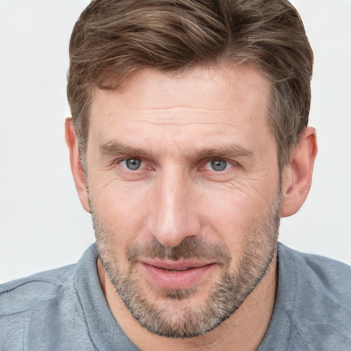 Joyful white adult male with short  brown hair and grey eyes