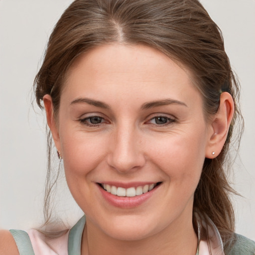 Joyful white young-adult female with medium  brown hair and blue eyes