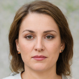 Joyful white young-adult female with medium  brown hair and green eyes