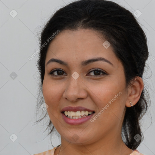 Joyful latino young-adult female with long  brown hair and brown eyes