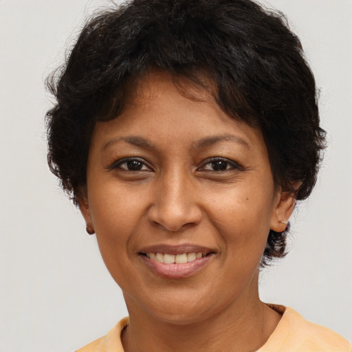 Joyful latino adult female with short  brown hair and brown eyes
