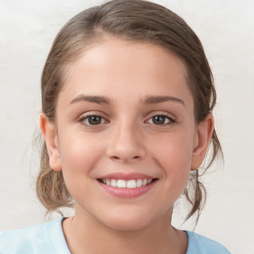 Joyful white child female with medium  brown hair and grey eyes