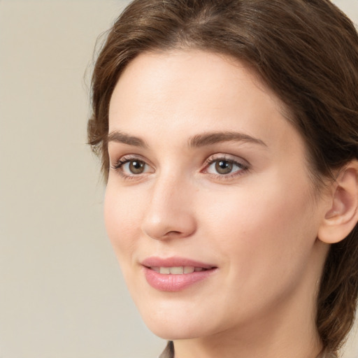 Joyful white young-adult female with medium  brown hair and green eyes