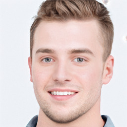 Joyful white young-adult male with short  brown hair and blue eyes