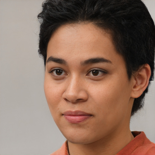 Joyful asian young-adult female with short  brown hair and brown eyes