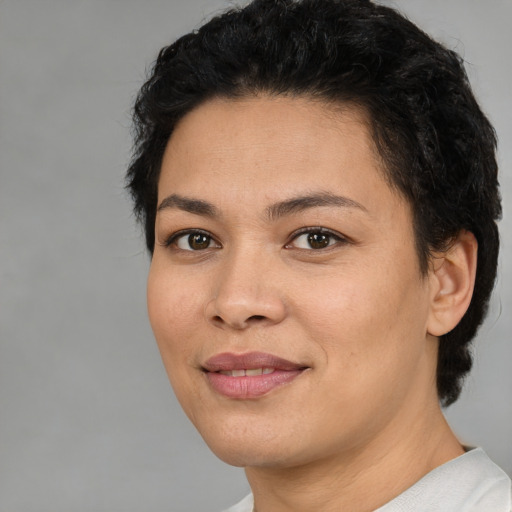 Joyful white young-adult female with short  black hair and brown eyes
