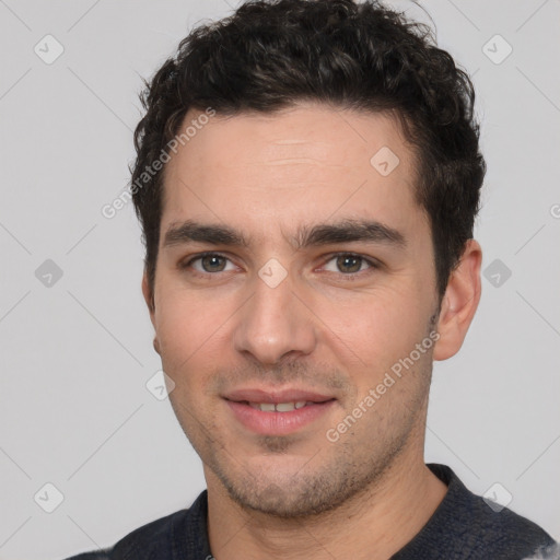 Joyful white young-adult male with short  black hair and brown eyes