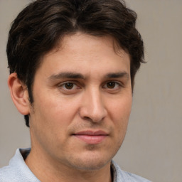 Joyful white adult male with short  brown hair and brown eyes