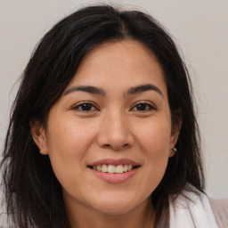 Joyful white young-adult female with long  brown hair and brown eyes