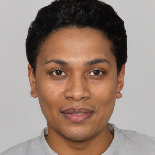 Joyful black young-adult female with short  black hair and brown eyes