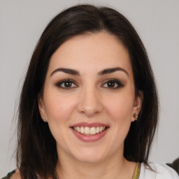 Joyful white young-adult female with medium  brown hair and brown eyes