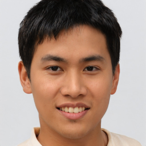 Joyful asian young-adult male with short  brown hair and brown eyes