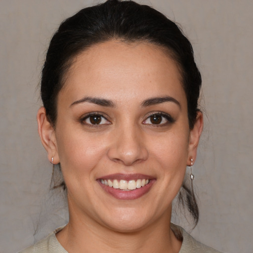 Joyful white young-adult female with medium  brown hair and brown eyes