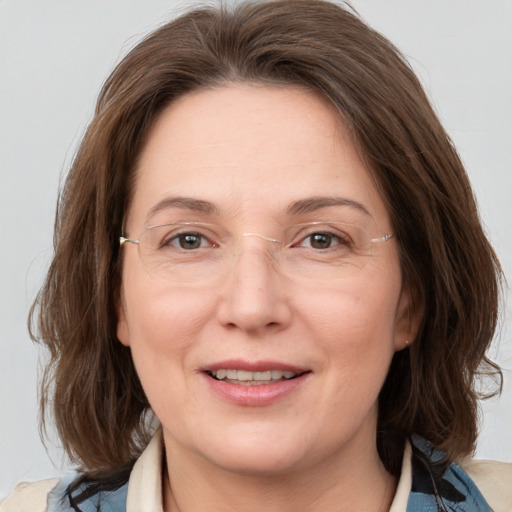 Joyful white adult female with medium  brown hair and brown eyes