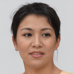 Joyful asian young-adult female with short  brown hair and brown eyes