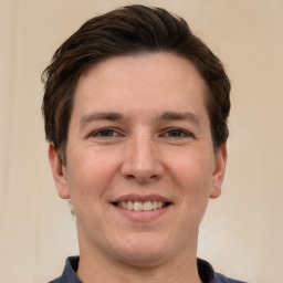 Joyful white young-adult male with short  brown hair and brown eyes