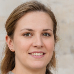 Joyful white young-adult female with medium  brown hair and grey eyes