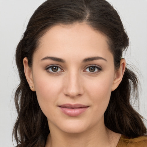 Joyful white young-adult female with long  brown hair and brown eyes