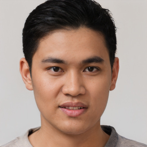 Joyful asian young-adult male with short  black hair and brown eyes