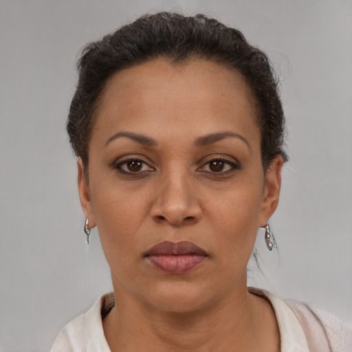 Joyful latino adult female with short  brown hair and brown eyes