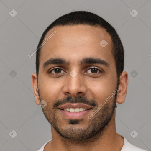 Joyful latino young-adult male with short  black hair and brown eyes