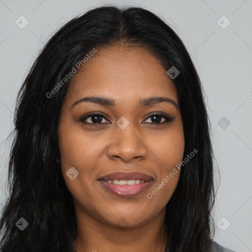 Joyful black young-adult female with long  brown hair and brown eyes