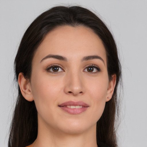 Joyful white young-adult female with long  brown hair and brown eyes
