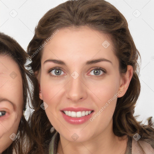 Joyful white young-adult female with long  brown hair and green eyes