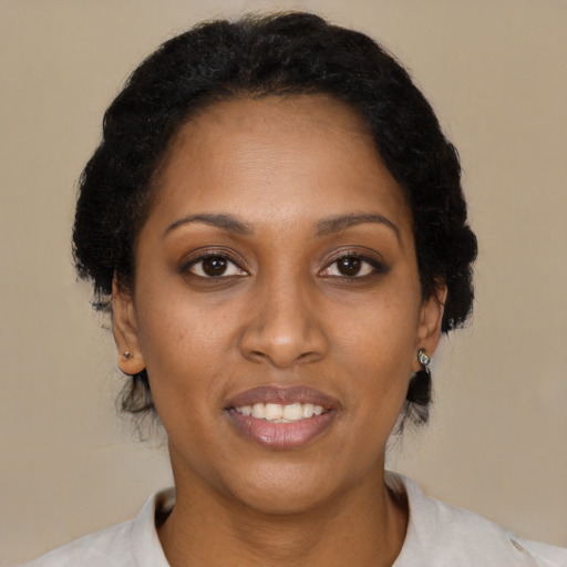 Joyful black adult female with short  brown hair and brown eyes